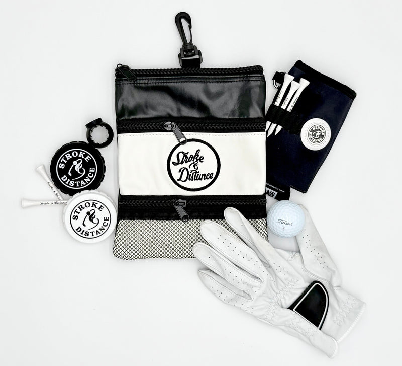 Collection of golf accessories including a bag, gloves, and a keychain on a white background.